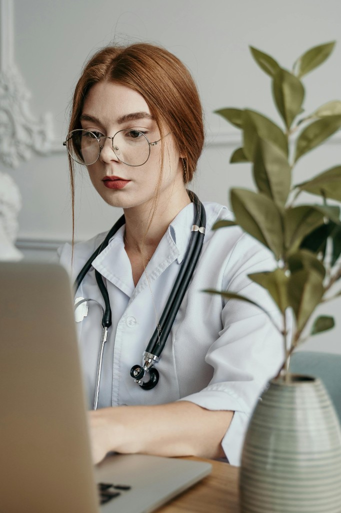 Doctor using Lanthocare EMR on laptop